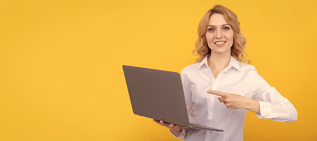 happy-entrepreneur-lady-white-shirt-pointing-finger-laptop-yellow-background-presentation_545934-36321